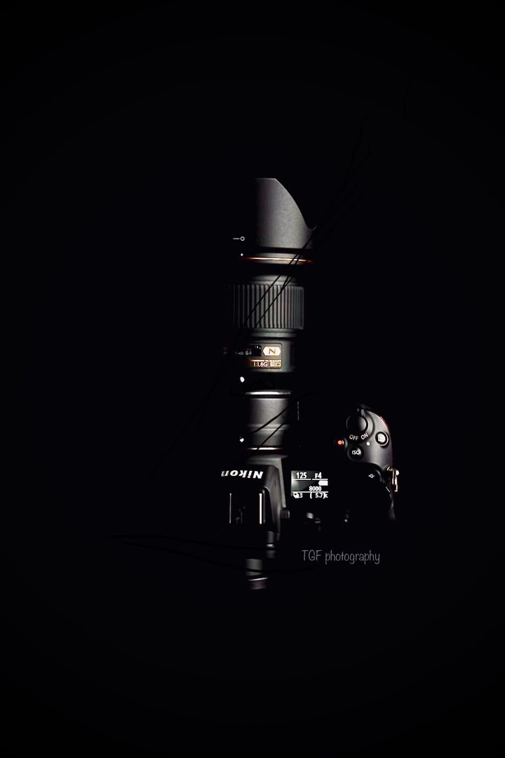 Nikon camera resting in the dark, TGF Photography